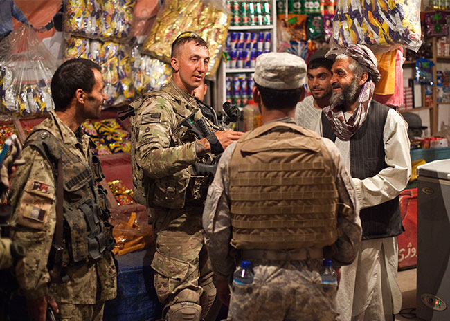 U.S. soldiers and Afghan men talking at a market