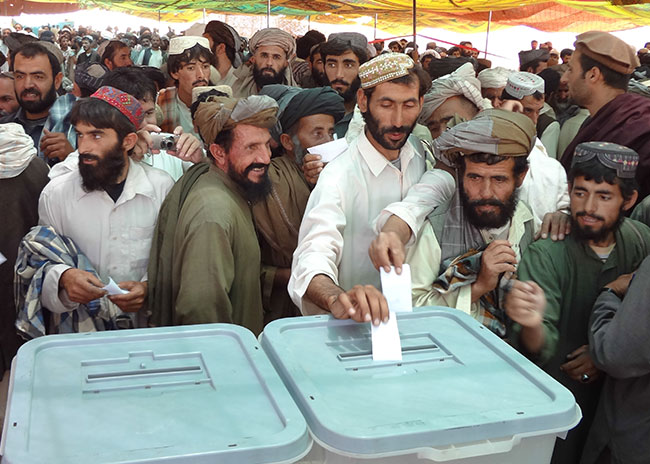 An Afghan man casts his ballot in an election