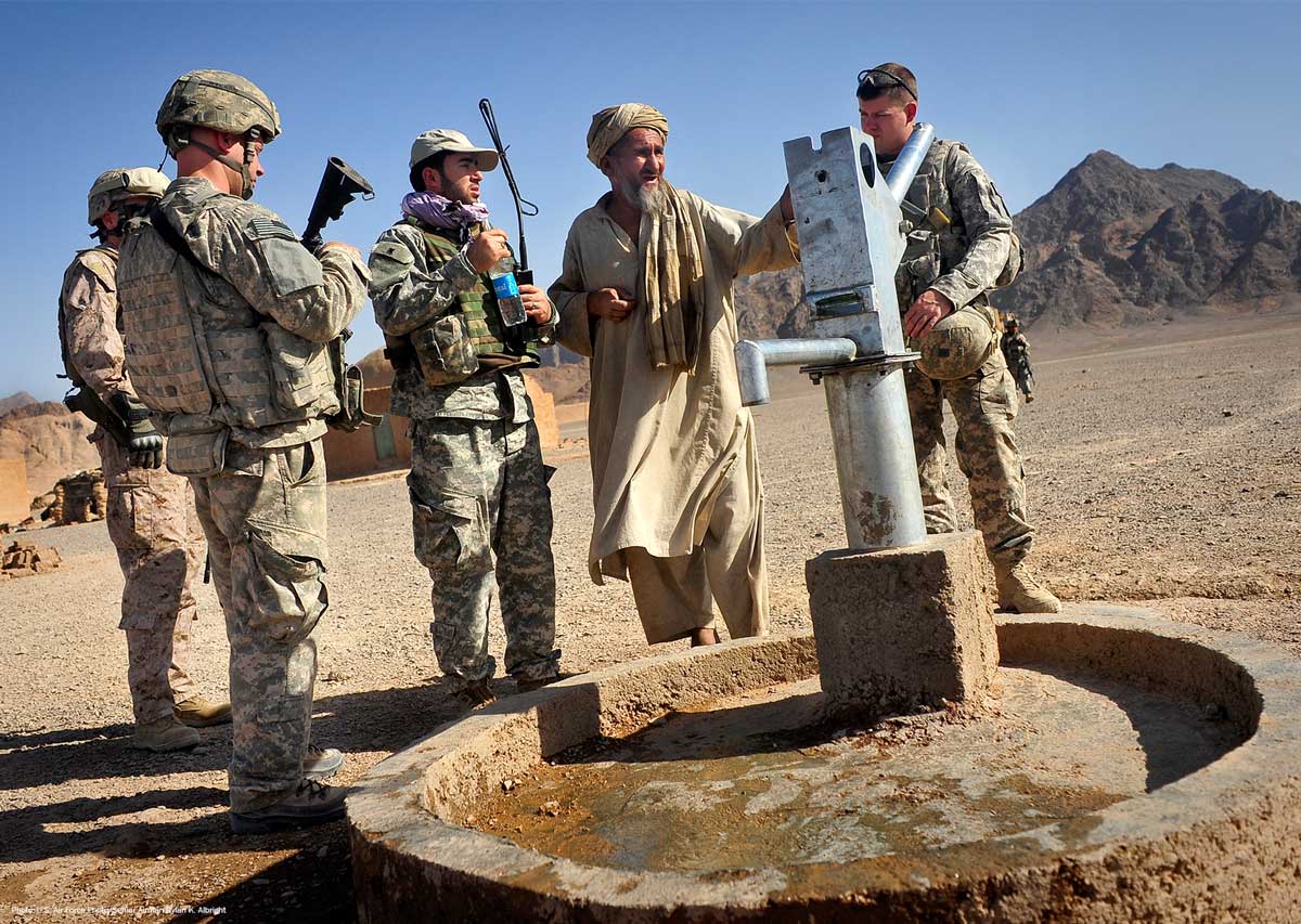 U.S. soldiers with a villager at a well