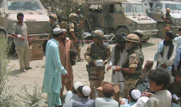 Members of PRT Kandahar and Italian troops deliver humanitarian aid to residents of Spin Boldak in 2003. (Photo by Harold Ingram)